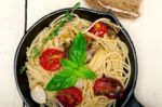 Spaghetti Pasta With Baked Cherry Tomatoes And Basil Stock Photo