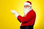 Side Profile Of Santa Facing Camera With Open Palms Stock Photo