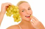 Woman Eating Grapes Stock Photo