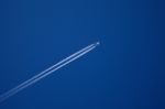 A Long Trail Of Jet Plane On Blue Sky Stock Photo