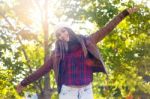 Portrait Of Beautiful Girl Standing In Autumn Field With Arms Ra Stock Photo