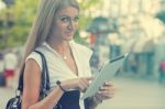 Woman With Ipad Tablet Computer Walking On Urban Street Stock Photo