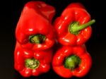 Top View Of Wet Red Peppers On Black Background Stock Photo