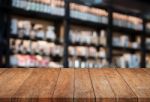 Perspective Top Wooden Table With Blurred Cafe Background Stock Photo