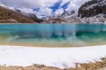 The Green Milk Lake Is Surrounded By Snow On The Mountains In Yading Nature Reserve Stock Photo