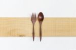 Red Wood Fork And Spoon On Wooden Plate Stock Photo