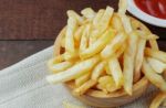 French Fries On Wooden Stock Photo