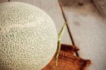 Melon On Wooden Floor Stock Photo