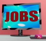 Jobs On Monitor Shows Employment Or Hiring Online Stock Photo