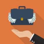 Hand With Briefcase Full Of Money Stock Photo