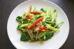 Stir Fried Kale With Bacon On Black Background , Thai Cuisine Stock Photo