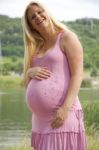 Pregnant Woman Relaxing By The Lake Stock Photo