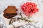 Raw Minced Meat With Bread And Rosemary Stock Photo