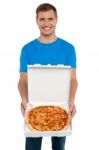 Smiling Young Man Showing Pizza Stock Photo