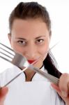 Female Chef Holding Cutlery Stock Photo