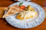 Omelet With Potato, Tomatoes Parsley And Feta Cheese And Bread In White Plate On Wooden Table Stock Photo