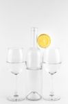 Isolated Bottle And Glasses With Lemon Stock Photo