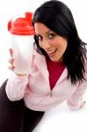 Front View Of Smiling Female With Bottle On White Background Stock Photo