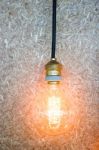 Vintage Hanging Light Bulb Decorated On Brown Wall Stock Photo