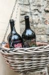 Two Beer Bottles In An Hanging Basket In Citta Alta Bergamo Stock Photo