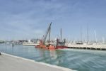 Dredger Coming Into Rimini Port Stock Photo