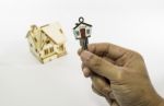 Holding House Key With Small Wooden House Stock Photo