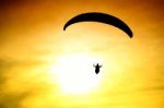 Silhouette Of Parachute On Sunset Stock Photo