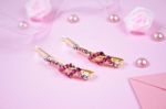 Golden Hairpins With Pink Gemstone On Pink Background Stock Photo