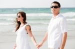 Couple Walking On The Beach Stock Photo