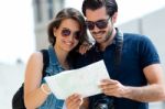 Young Tourist Couple In Town Holding A Map Stock Photo