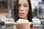 Young Female Working Out With Dumbbells In A Gym Stock Photo