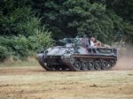 People Enjoying A Ride In An Armoured Car At Dunsfold Airfield Stock Photo