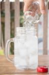 Drinking Water Is Poured Into Iced Glass Stock Photo