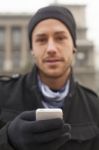 Man With Mobile Phone In Hands Stock Photo