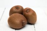 Tasty Kiwi Fruits Isolated On A White Wooden Background Stock Photo