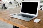 Blank Screen Laptop Computer On Wood Table Stock Photo