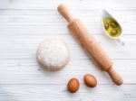 Raw Pizza Dough And Rolling Pin On Wooden Background Stock Photo