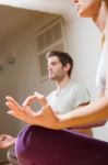 Couple Sitting On Floor Doing Yoga Stock Photo