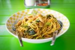 Stir Fried Yellow Noodles With Basil Leaf, Chili And Pork Stock Photo