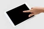 Finger Being Pointed On Tablet Screen Stock Photo