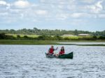 People Canoeing On The River Alde Stock Photo