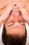 Close-up Of Young Man Getting Face Massage Stock Photo