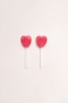 Two Pink Valentine's Day Heart Shape Lollipop Candy On Empty White Paper Background. Love Concept. Knolling Top View. Minimalism Colorful Hipster Style Stock Photo