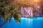 Tropical Beach And Long Boat With Palm Trees In Phi Phi Island, Krabi Thailand Stock Photo