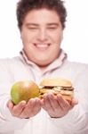 Chubby Man Holding Apple And Hamburger Stock Photo