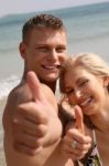 Young Couple Showing Thumbs Up Stock Photo