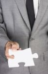 Businessman Holding Blank Jigsaw Stock Photo