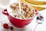 Pour Milk Into The Bowl For Healthy Breakfast Stock Photo