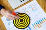 Business Man Hand Holding A Target With Darts Hitting The Center Stock Photo