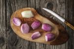 Shallot On The Wooden Board With Knife Top View Stock Photo